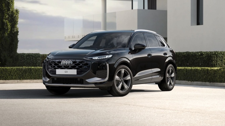 Black Audi Q3 SUV S line trim level modern building background