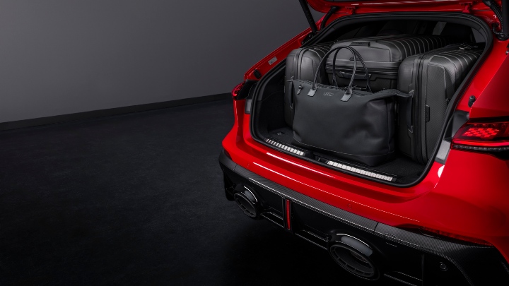 Red Audi RS 5 Avant rear boot open full of bags