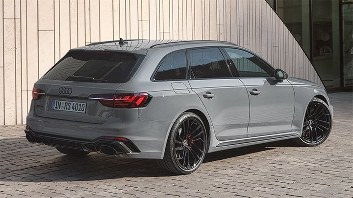 Rear quarter shot of a grey Audi RS 4 Avant parked in front of a modern building