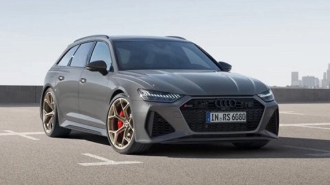 Grey Audi RS6 Avant parked on the asphalt with large skyscrapers in the background