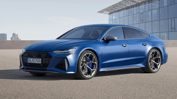Blue Audi RS7 Sportback parked in front of a modern building made with glass walls