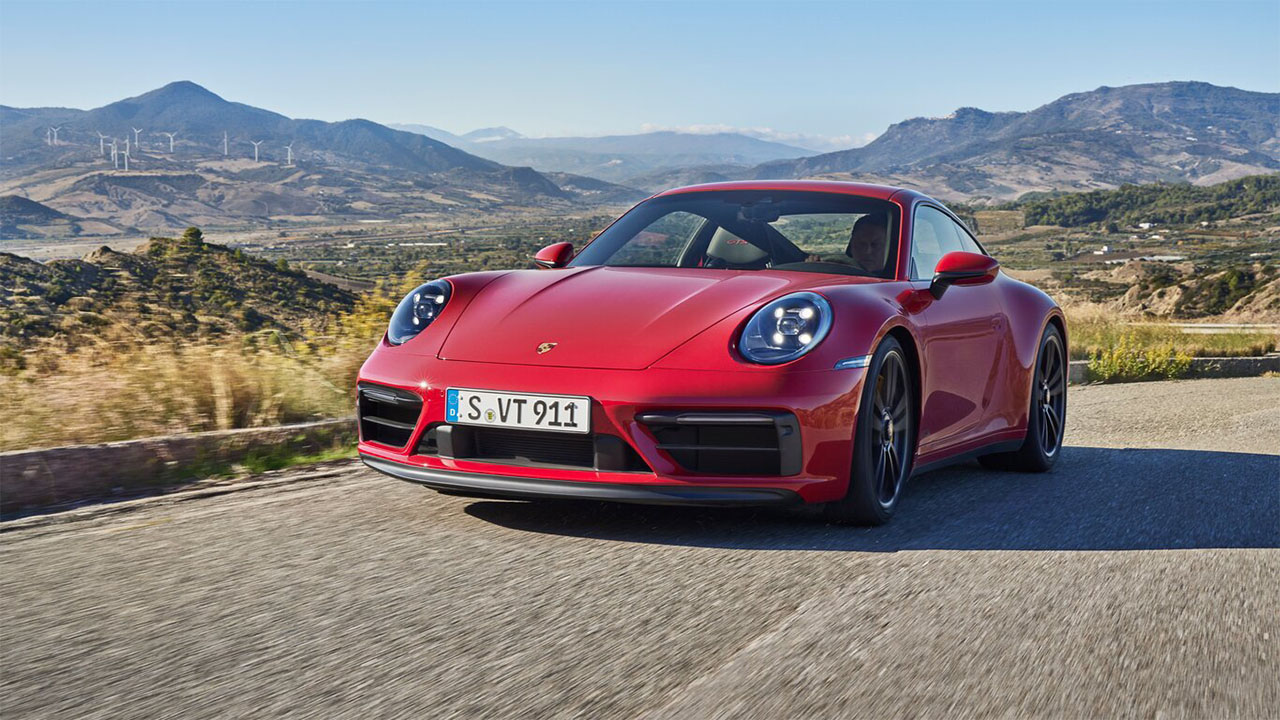 Red Porsche 911, driving in the countryside