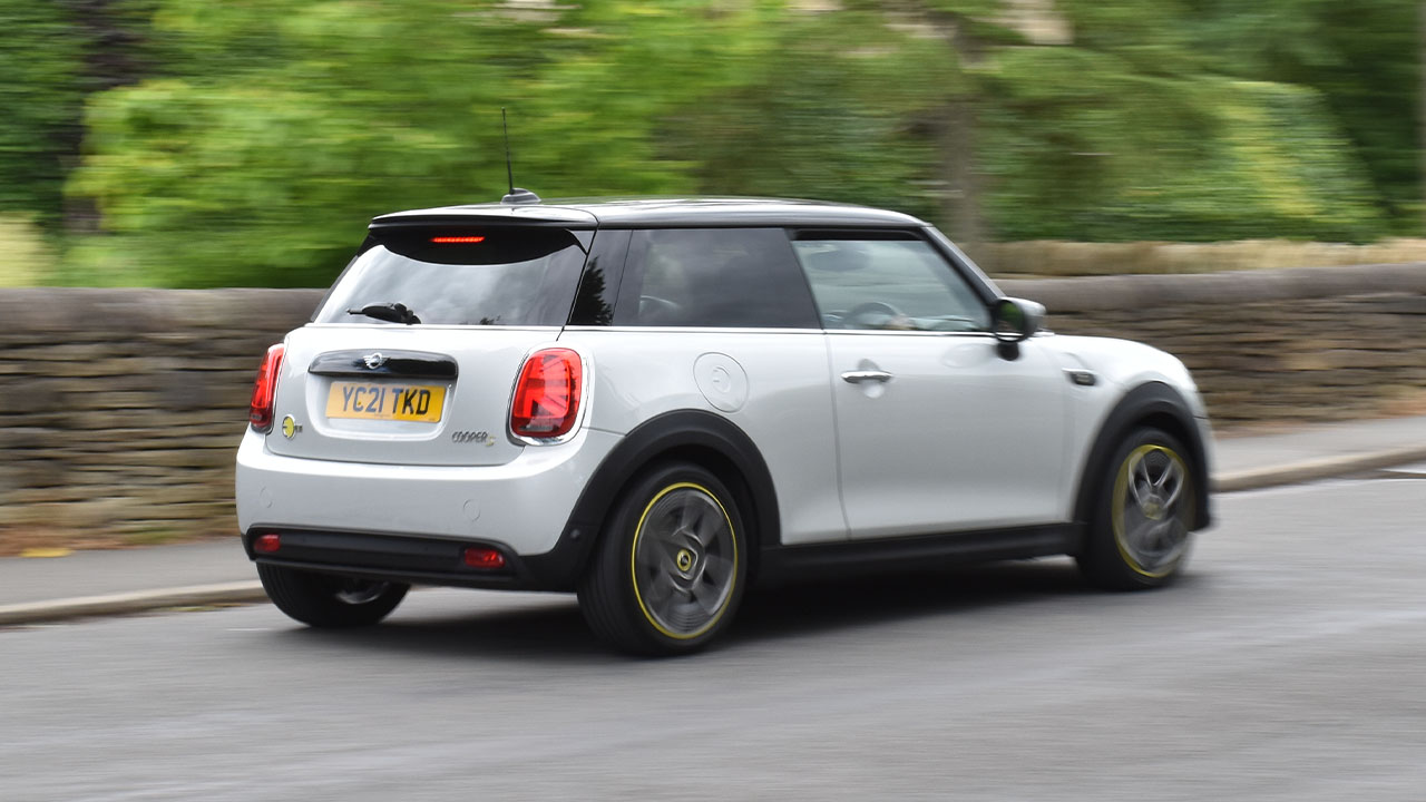 MINI Electric, rear quarter shot, driving in rural village
