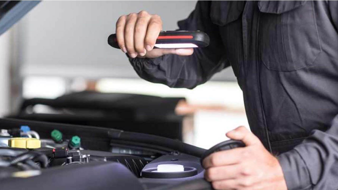 technician performing fluid check