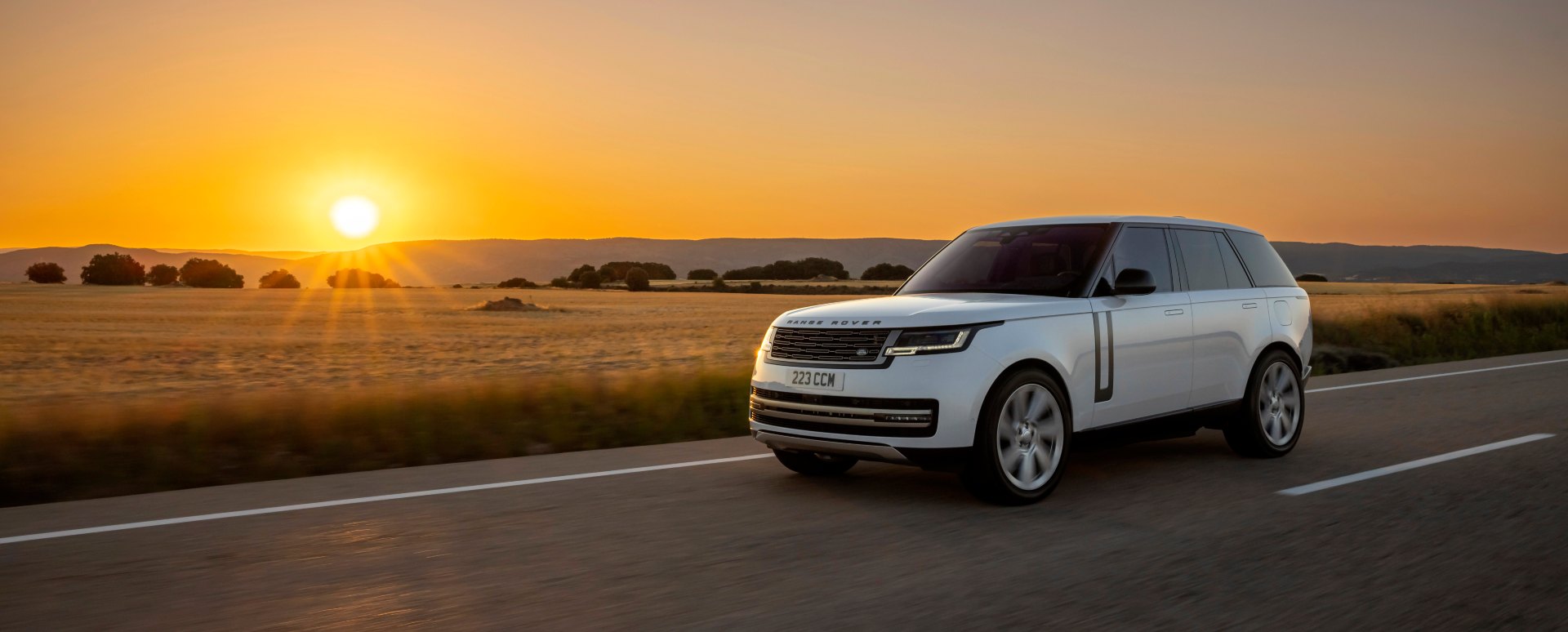 White Range Rover Exterior Front Driving at Sunset