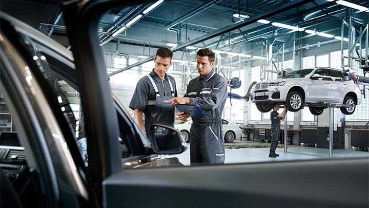 two bmw technicians comparing notes