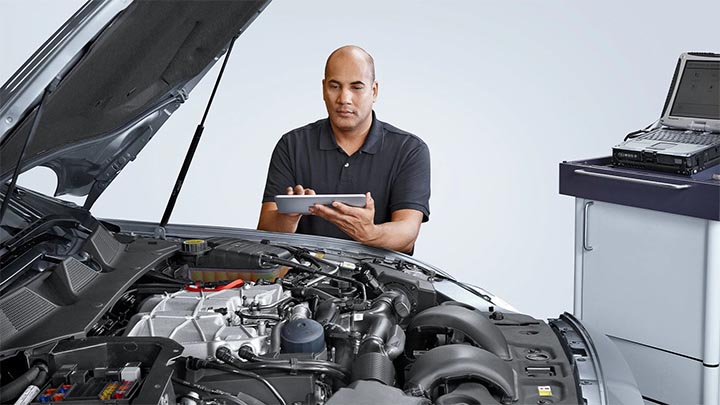 technician inspecting jaguar engine bay