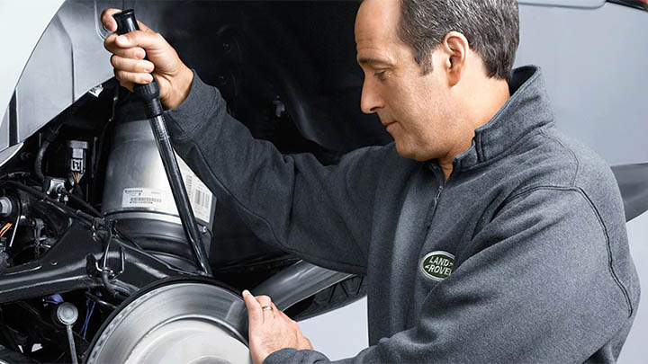 land rover technician completing brake repair