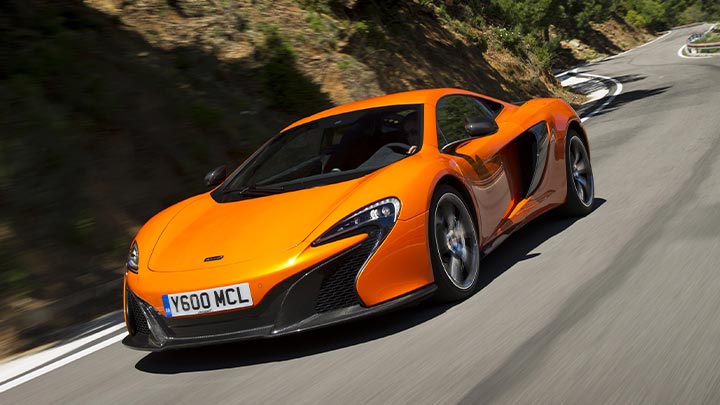 Orange McLaren 650S Driving On Mountain Road