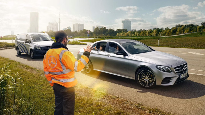 Breakdown Technician Greeting Mercedes-Benz Driver
