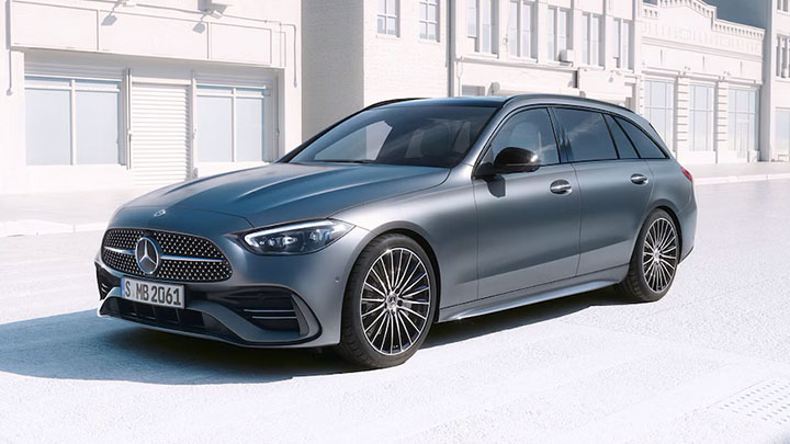 Grey Mercedes-Benz C-Class parked in front of white houses